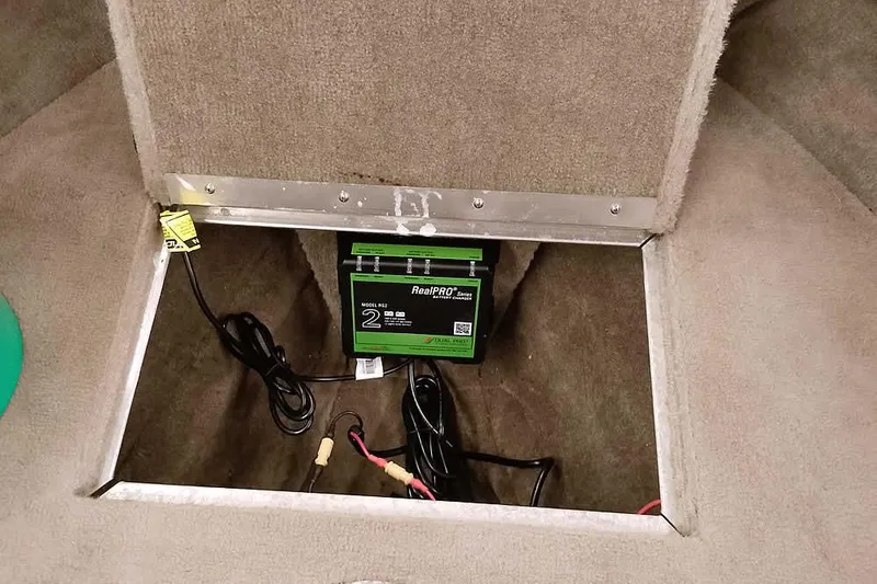 Slide: The Image of Battery compartment of a 2005 Monark King 185 with RealPRO battery charger. - 17