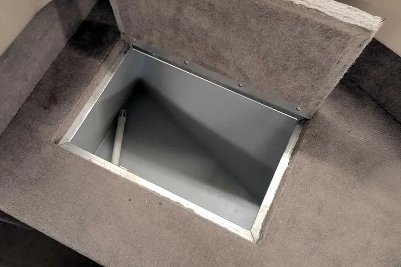 Slide: The Image of Open storage compartment in 2005 Monark King 185 boat, featuring carpeted interior. - 18