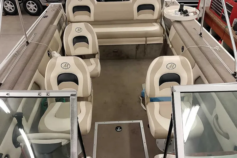 Slide: The Image of 2005 Monark King 185 boat interior with beige seating and windshield. - 20