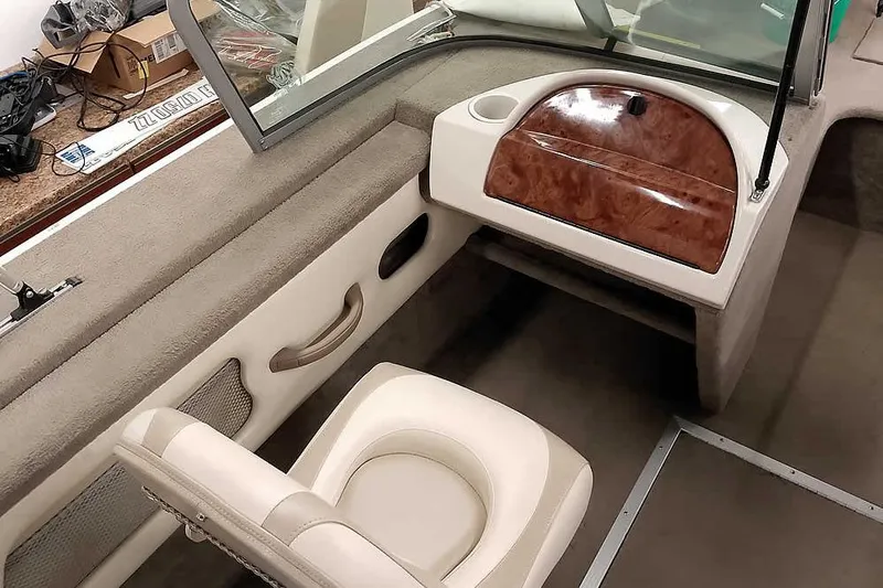 Slide: The Image of Interior of a 2005 Monark King 185 boat, featuring seating and dashboard details. - 21