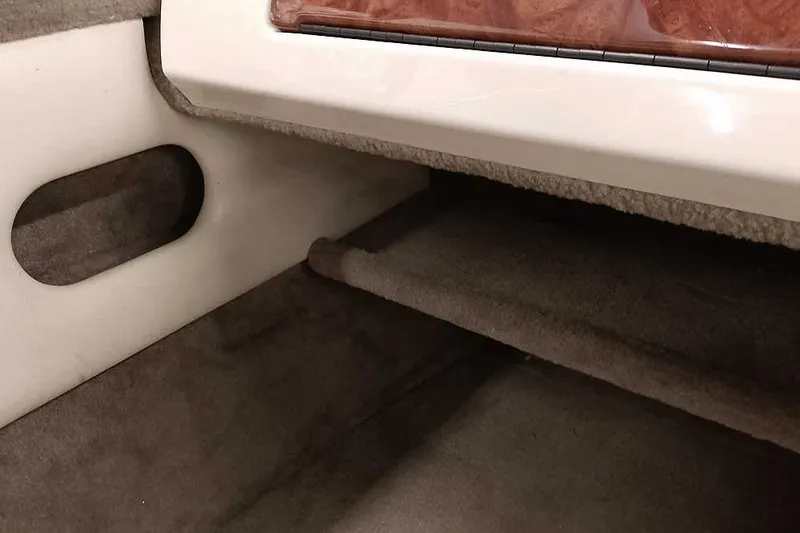 Slide: The Image of Interior of 2005 Monark King 185 boat, featuring carpeted storage area. - 22