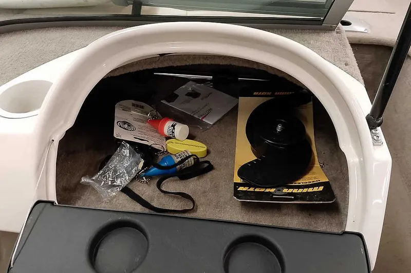 Slide: The Image of Storage compartment of 2005 Monark King 185 boat with various accessories and tools. - 23