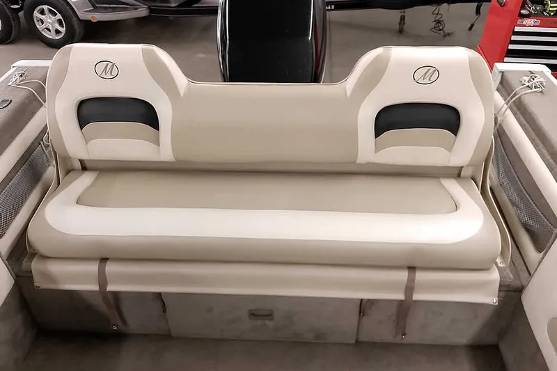 Slide: The Image of 2005 Monark King 185 boat interior with beige seating and storage compartments. - 31