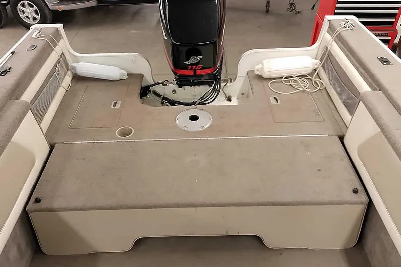 Slide: The Image of 2005 Monark King 185 boat interior with motor and seating area. - 33