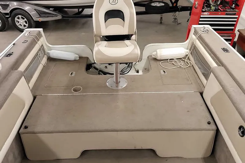 Slide: The Image of Interior of a 2005 Monark King 185 boat with seating and storage compartments. - 34