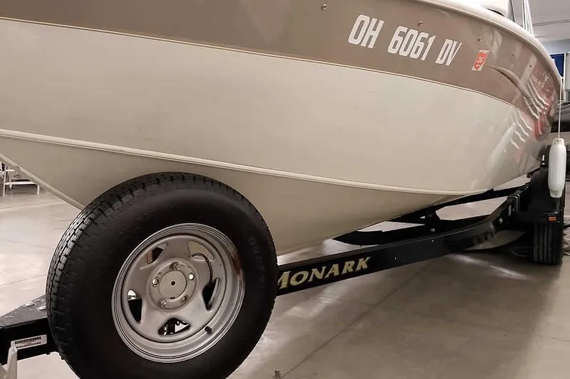 Slide: The Image of 2005 Monark King 185 boat on trailer, displaying registration number OH 6061 DV. - 7