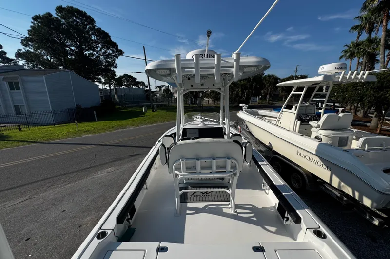 Slide: The Image of 2024 Tidewater 2300 Carolina Bay boat with T-top and seating, parked on a street. - 10