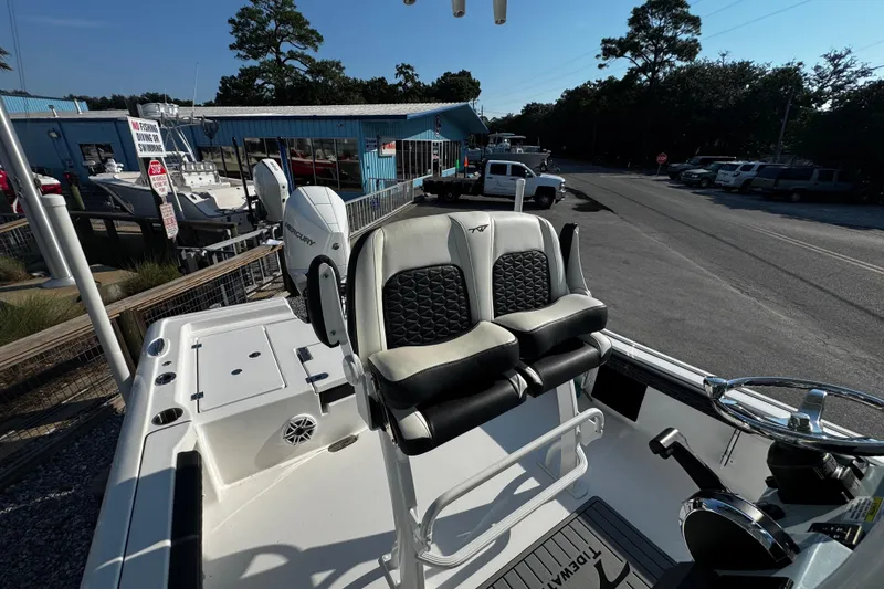 Slide: The Image of 2024 Tidewater 2300 Carolina Bay boat with dual seats and Mercury engine. - 14