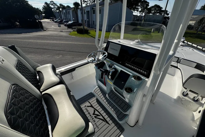 Slide: The Image of 2024 Tidewater 2300 Carolina Bay boat interior with steering console and seating. - 15
