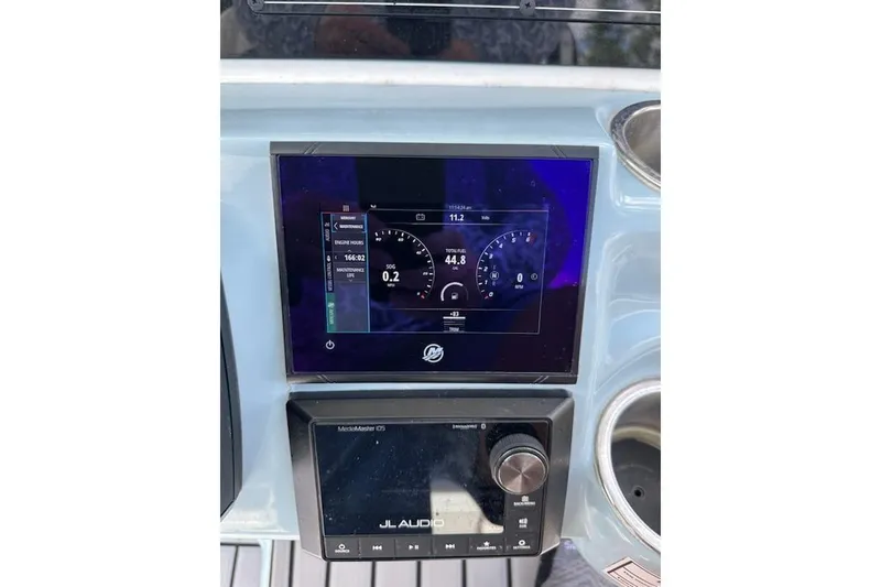 Slide: The Image of 2024 Tidewater 2300 Carolina Bay dashboard with digital display and JL Audio system. - 16