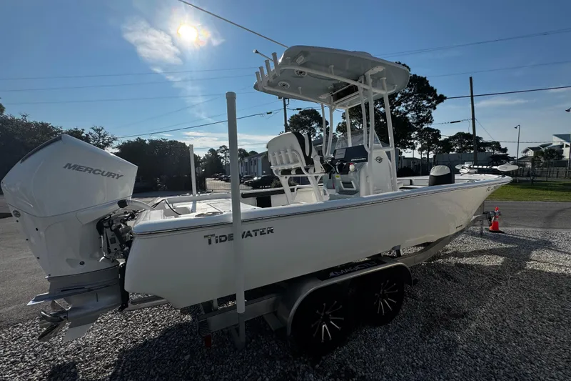 Slide: The Image of 2024 Tidewater 2300 Carolina Bay boat with Mercury engine on a trailer, parked outdoors. - 4