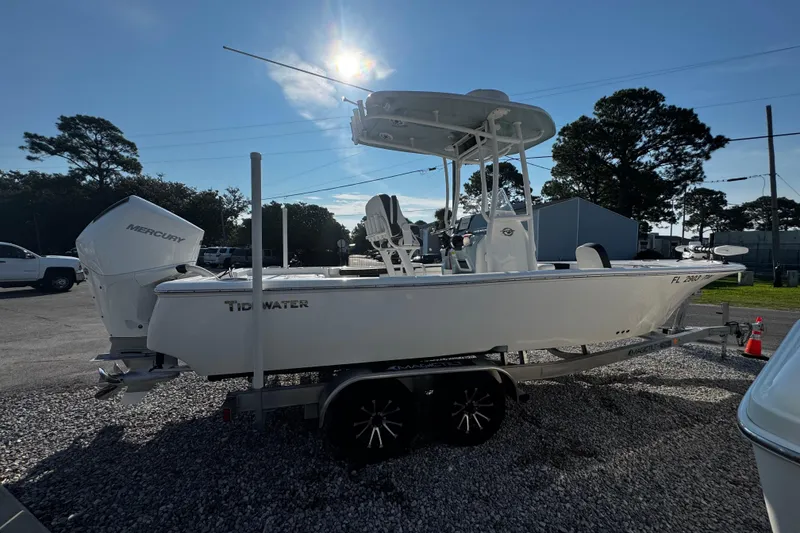 Slide: The Image of 2024 Tidewater 2300 Carolina Bay boat on trailer, parked outdoors under sunny sky. - 5