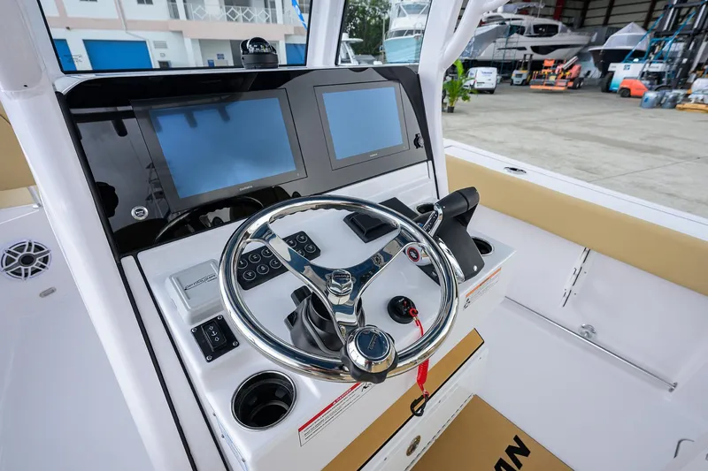 Slide: The Image of 2026 Sportsman Heritage 261 Center Console helm with dual screens and modern controls. - 16