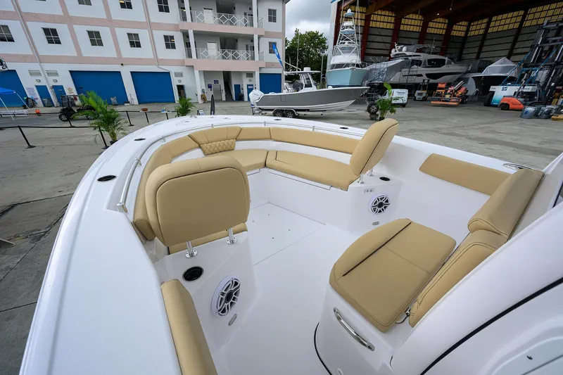 Slide: The Image of 2026 Sportsman Heritage 261 Center Console boat with beige seating in a marina setting. - 18