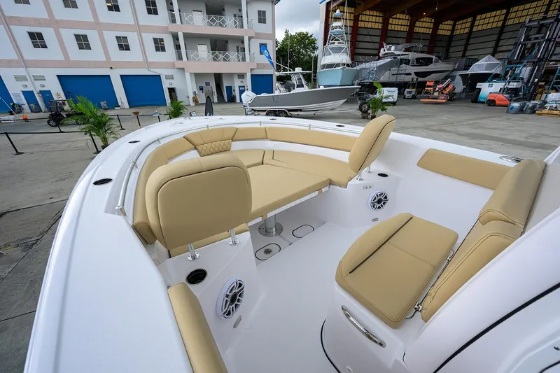 Slide: The Image of 2026 Sportsman Heritage 261 Center Console boat with beige seating in a marina setting. - 20