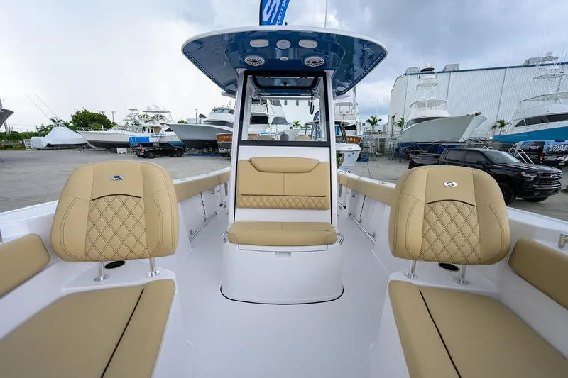 Slide: The Image of 2026 Sportsman Heritage 261 Center Console boat with tan seating and modern design. - 22