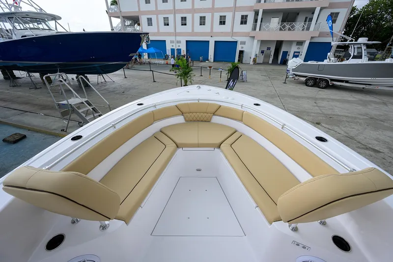 Slide: The Image of 2026 Sportsman Heritage 261 Center Console boat with tan seating at a marina. - 23
