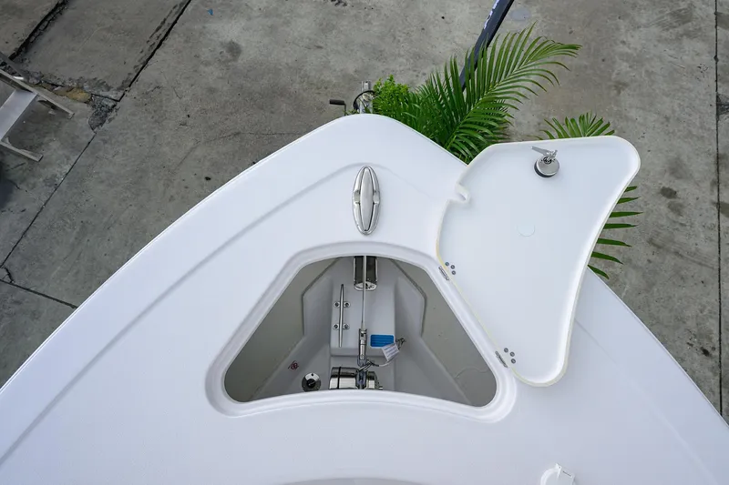 Slide: The Image of 2026 Sportsman Heritage 261 Center Console boat anchor compartment, open lid, top view. - 24