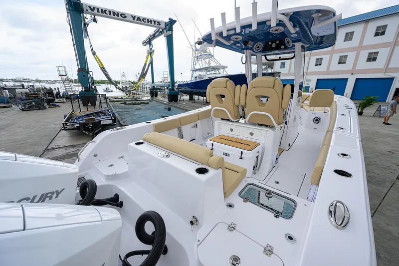 Slide: The Image of 2026 Sportsman Heritage 261 Center Console boat at marina with Viking Yachts crane. - 4