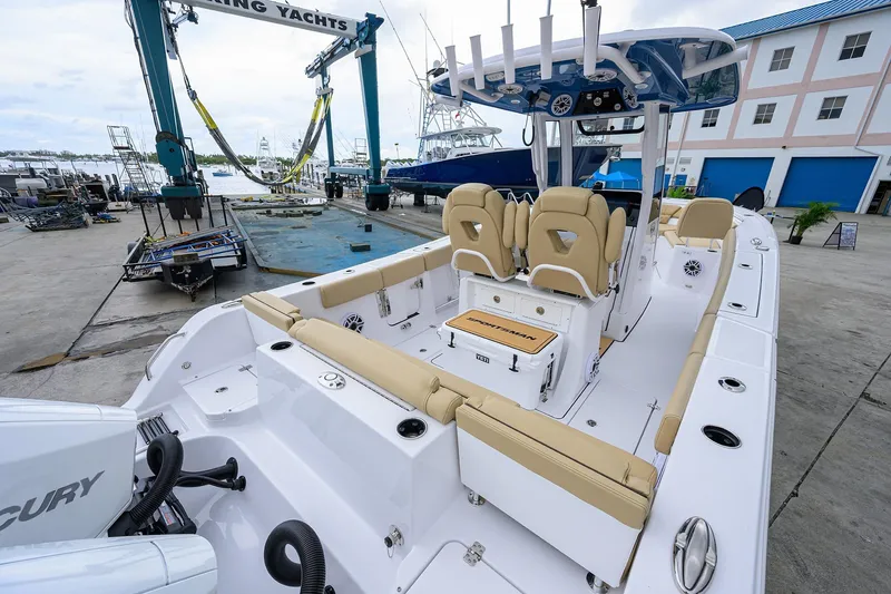 Slide: The Image of 2026 Sportsman Heritage 261 Center Console boat at marina, featuring spacious seating and modern design. - 5