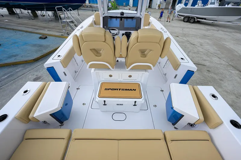 Slide: The Image of 2026 Sportsman Heritage 261 Center Console boat interior with beige seating and modern design. - 6