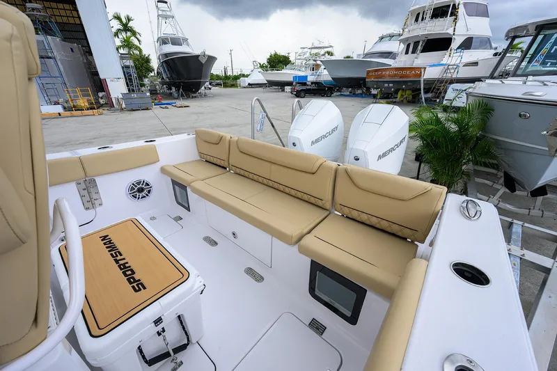 Slide: The Image of 2026 Sportsman Heritage 261 Center Console boat with tan seating and Mercury engines. - 8