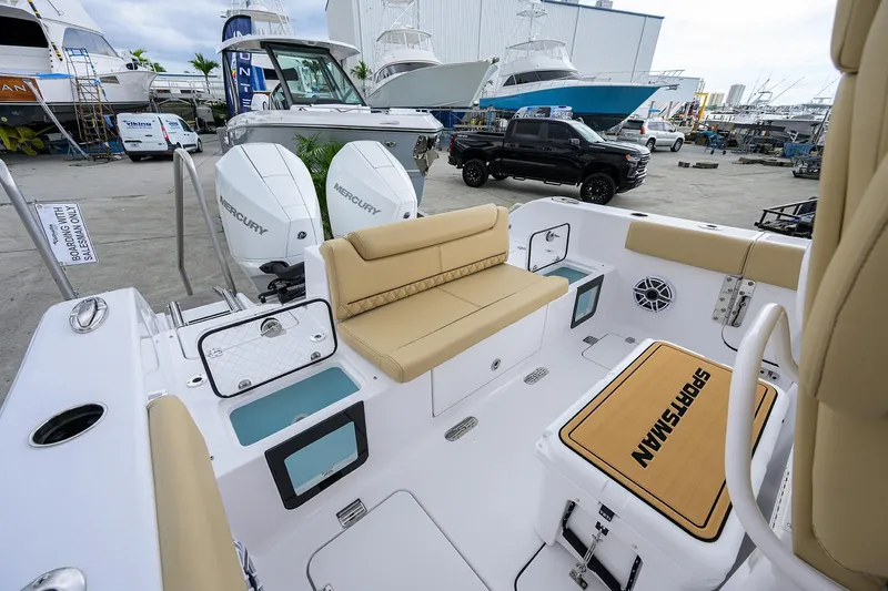 Slide: The Image of 2026 Sportsman Heritage 261 Center Console boat interior with seating and Mercury engines. - 9