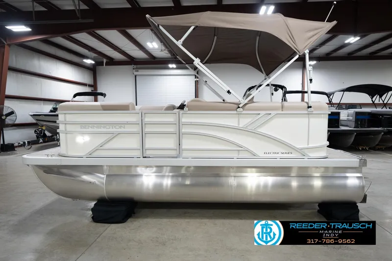 Slide: The Image of 2026 Bennignton 168 SL pontoon boat in showroom, featuring canopy and sleek design. - 10