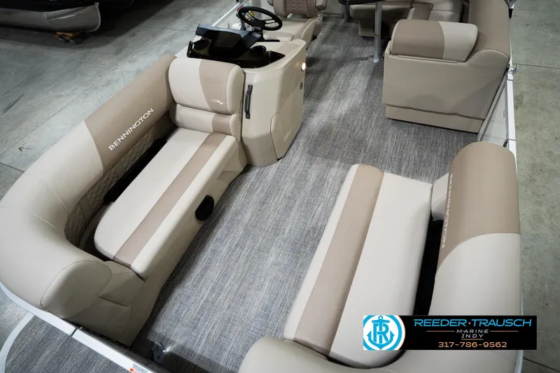 Slide: The Image of 2026 Bennignton 168 SL pontoon boat interior with beige seating and steering console. - 11