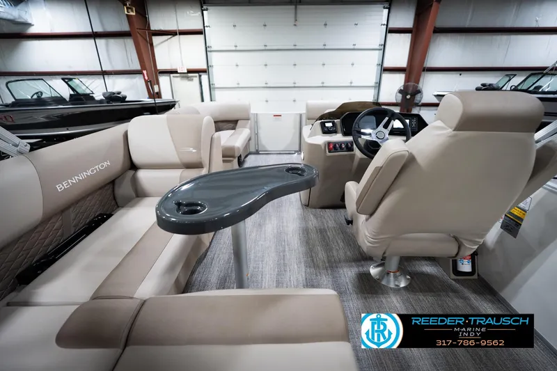 Slide: The Image of 2026 Bennignton 168 SL boat interior with beige seating and steering console. - 17