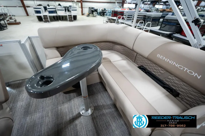 Slide: The Image of 2026 Bennington 168 SL boat interior with beige seating and a sleek gray table. - 20