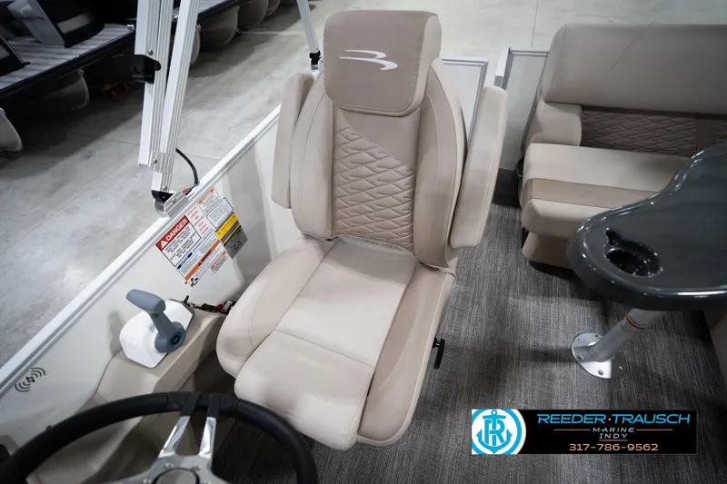 Slide: The Image of 2026 Bennignton 168 SL boat interior with beige captain's chair and control panel. - 26
