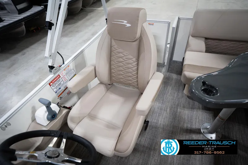 Slide: The Image of 2026 Bennignton 168 SL boat interior with beige captain's chair and steering wheel. - 27