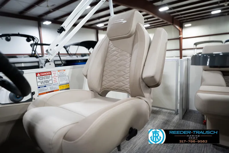 Slide: The Image of 2026 Bennignton 168 SL boat seat in showroom, featuring beige upholstery and armrests. - 40
