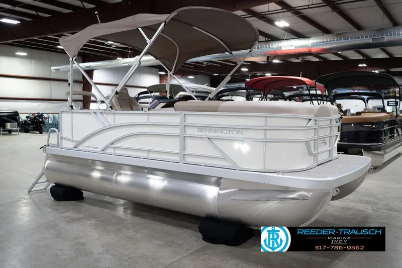 Slide: The Image of 2026 Bennignton 168 SL pontoon boat in showroom, featuring sleek design and canopy. - 5
