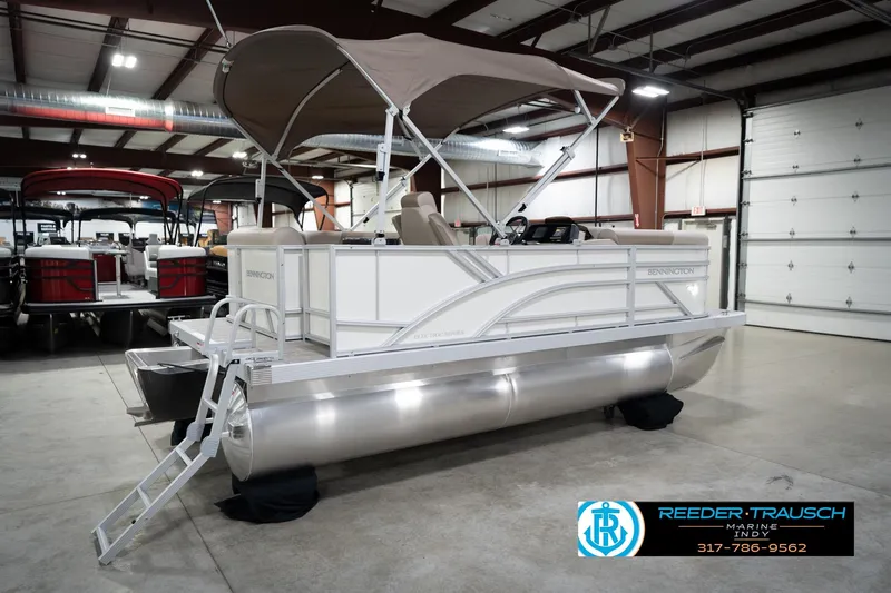 Slide: The Image of 2026 Bennignton 168 SL pontoon boat in showroom with canopy and ladder. - 7