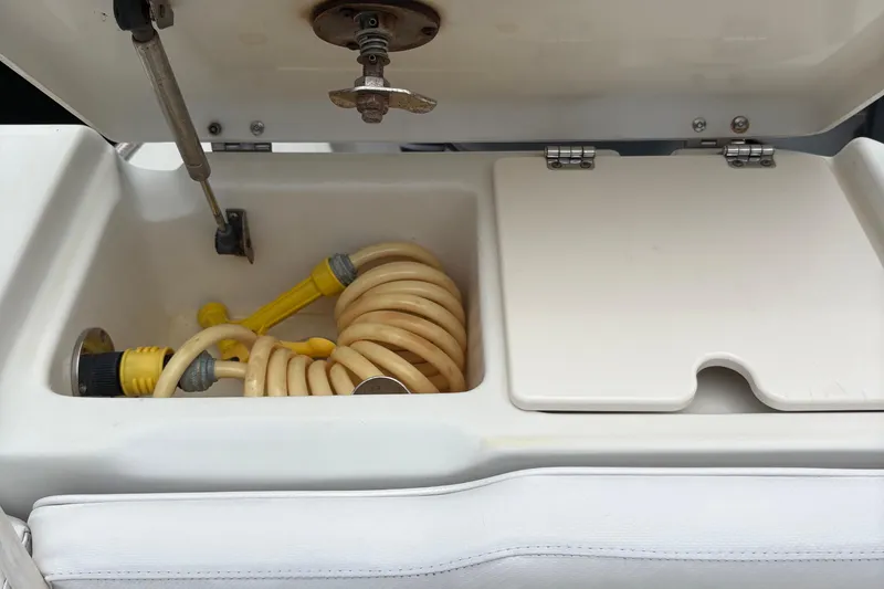 Slide: The Image of Storage compartment with coiled hose on a 2007 Hydra-Sports Vector 3300 CC boat. - 22