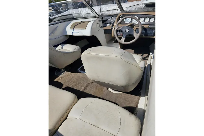 Slide: The Image of Interior of a 2003 Glastron SFSX175 boat with beige seating and dashboard. - 3