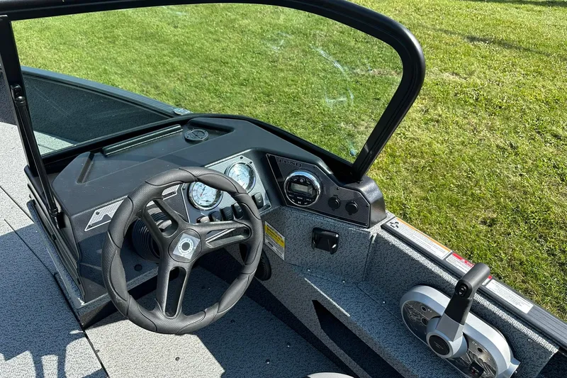 Slide: The Image of 2026 Lund 1775 Adventure Sport boat dashboard with steering wheel and controls. - 14