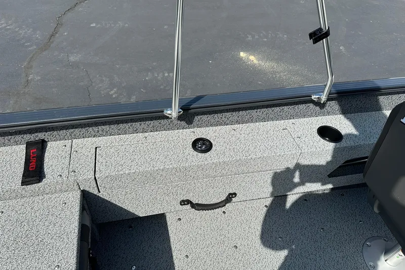 Slide: The Image of 2026 Lund 1775 Adventure Sport boat interior with gray textured flooring and seating. - 18