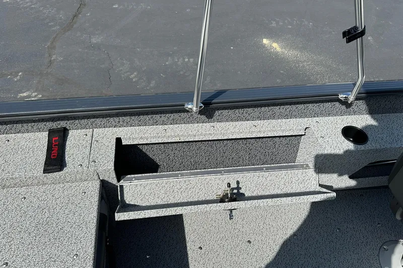 Slide: The Image of 2026 Lund 1775 Adventure Sport boat interior with storage compartment and cup holder. - 21