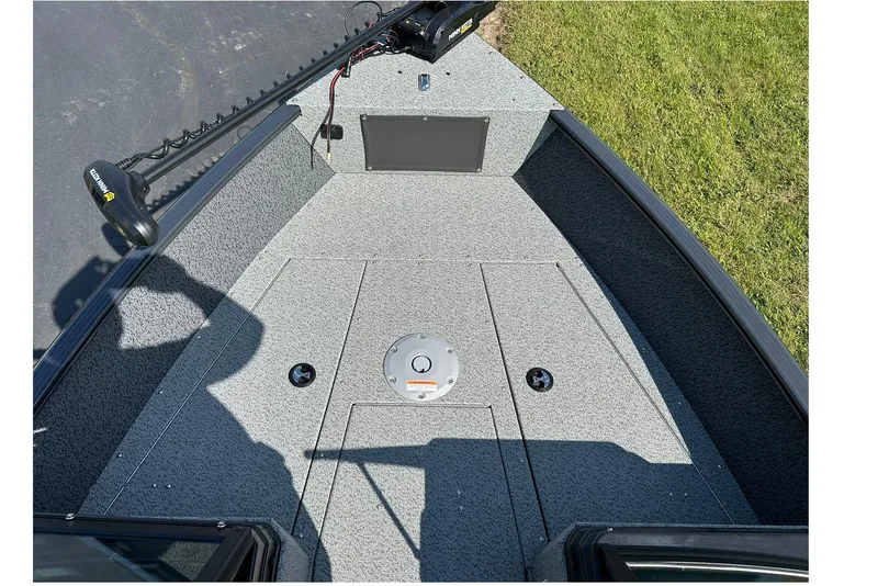 Slide: The Image of 2026 Lund 1775 Adventure Sport boat deck with trolling motor, gray carpet, and storage compartments. - 6