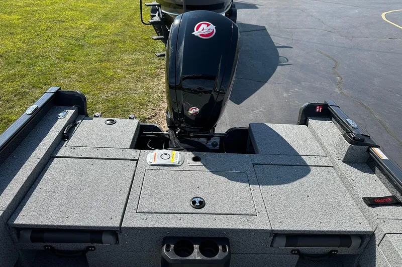 Slide: The Image of 2026 Lund 1775 Adventure Sport boat with Mercury outboard engine, parked on pavement. - 9