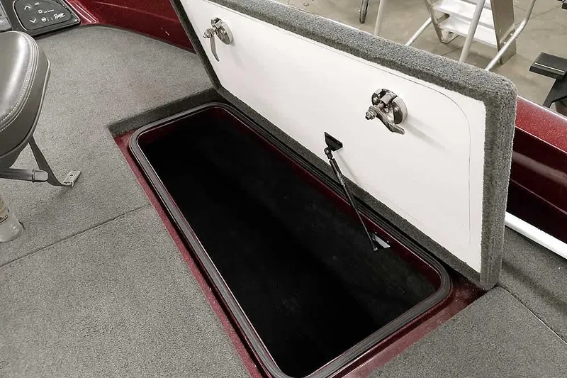 Slide: The Image of Open storage compartment in 2014 Ranger 621VS Fisherman boat, featuring carpeted interior. - 15