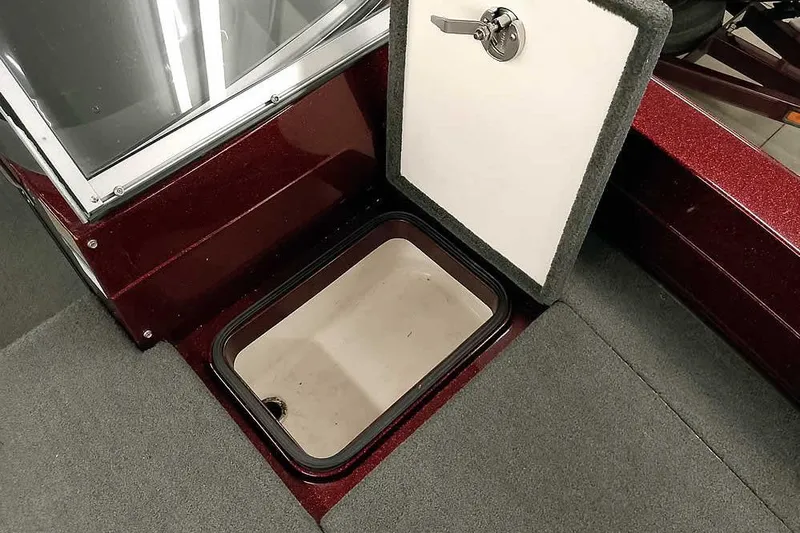 Slide: The Image of 2014 Ranger 621VS Fisherman boat storage compartment with open hatch, carpeted interior. - 16