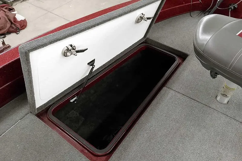 Slide: The Image of 2014 Ranger 621VS Fisherman boat storage compartment with open lid and seat. - 17