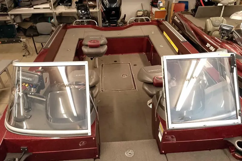 Slide: The Image of 2014 Ranger 621VS Fisherman boat interior with seating and equipment in a garage setting. - 19