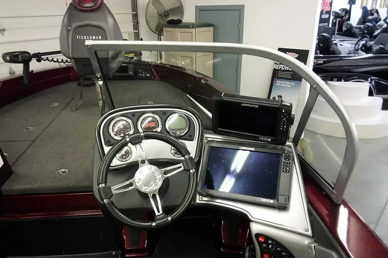 Slide: The Image of 2014 Ranger 621VS Fisherman boat dashboard with steering wheel and navigation screens. - 21