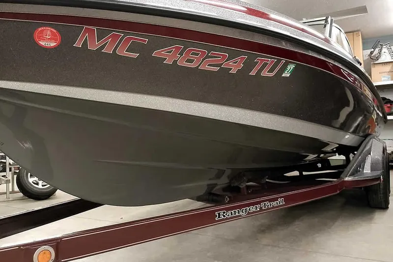 Slide: The Image of 2014 Ranger 621VS Fisherman boat on trailer, garage setting, registration number visible. - 8
