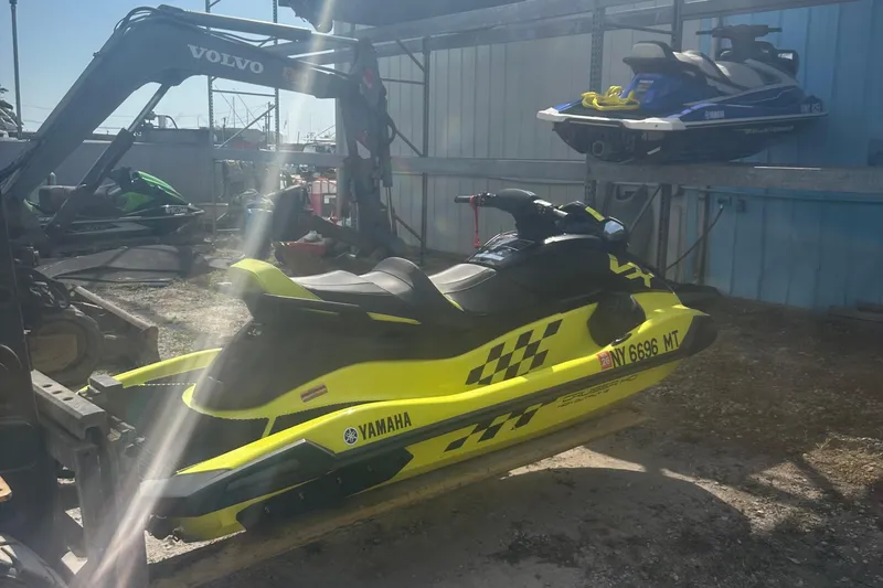 Slide: The Image of 2023 Yamaha WaveRunner VX Cruiser HO in a storage area with other jet skis. - 4